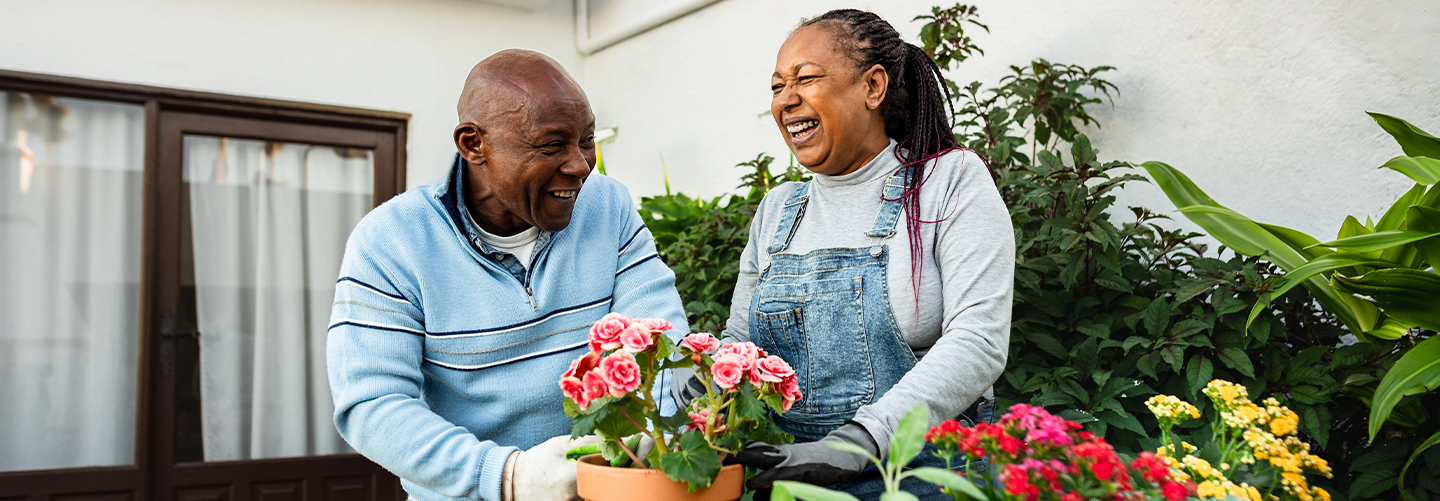 A couple laughing while gardening