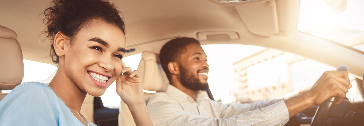 A couple smiling in a car